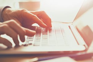 A closeup of an office worker using a computer keyboard