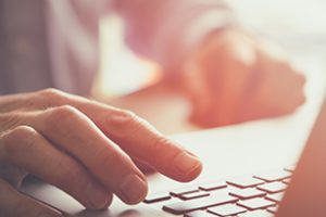 A closeup of an office worker using a computer keyboard