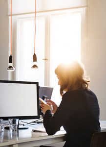 oung Casual Businesswoman With Smart Phone In Start-Up Office