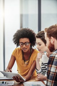 Three people Discussing key points of interest