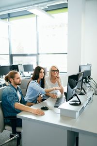 IT office. People Working At Open Workplace